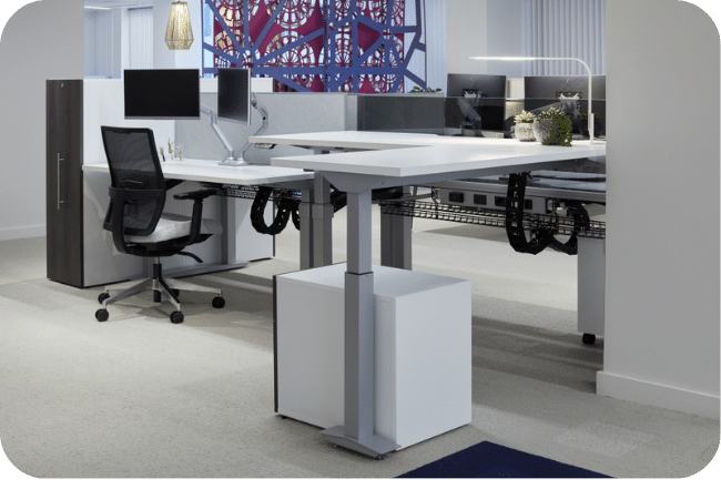 Open office workspace with adjustable-height desks and ergonomic seating.