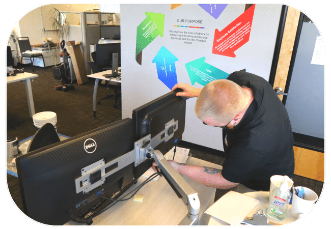 A person is working on assembling or repairing a piece of office equipment.