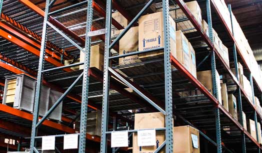 Tall warehouse storage racks filled with boxed inventory.