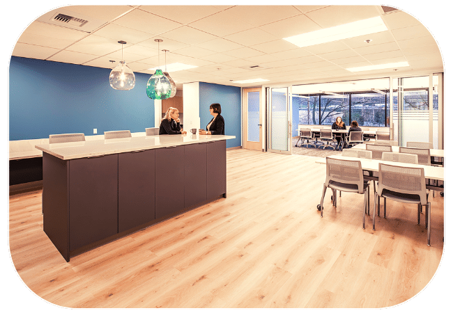  An open-concept office space with a reception desk, chairs, and other furniture. 